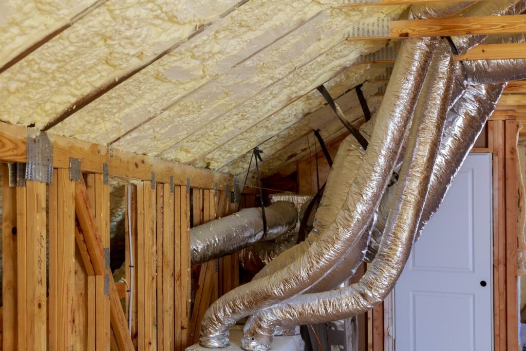 Open AC Heating Vent and Tubing in Ceiling of New Home Construction. vent pipes in attic